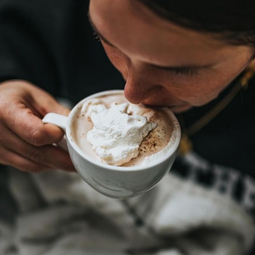 man sipping a hot beverage